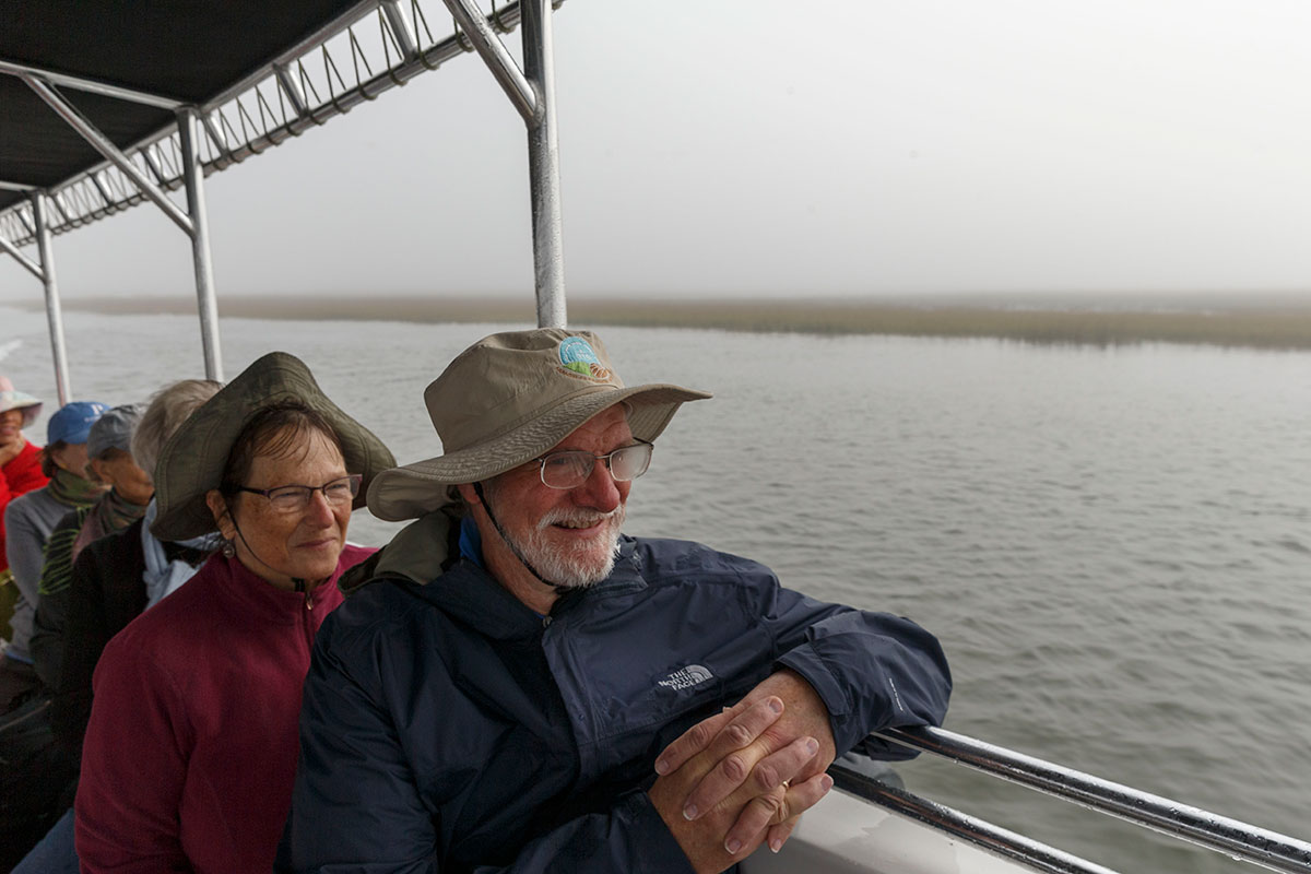 Tourists John and Mary Droske of Amherst, Wis., enjoy a naturalist-led ride to St. Phillips Island. Even on a warm day, it's best to bundle up for the early morning trip along the Story River, where dolphins often surface beside the boat.