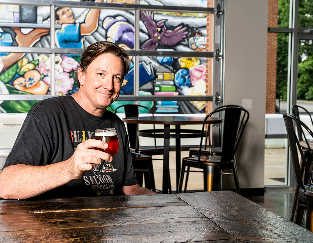Owner Russ Broome enjoys a cold one, in-house. “We have the best available beer and wine, up and down the price spectrum,” said Broome.