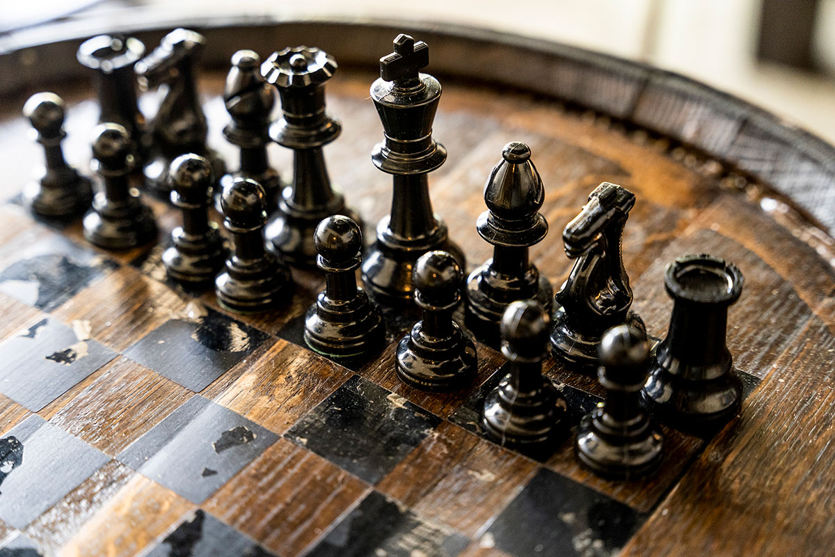 Patrons are invited to enjoy a game of chess over a glass of wine.