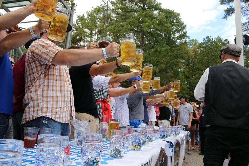 Stein hoisting competitors hold steins of beer